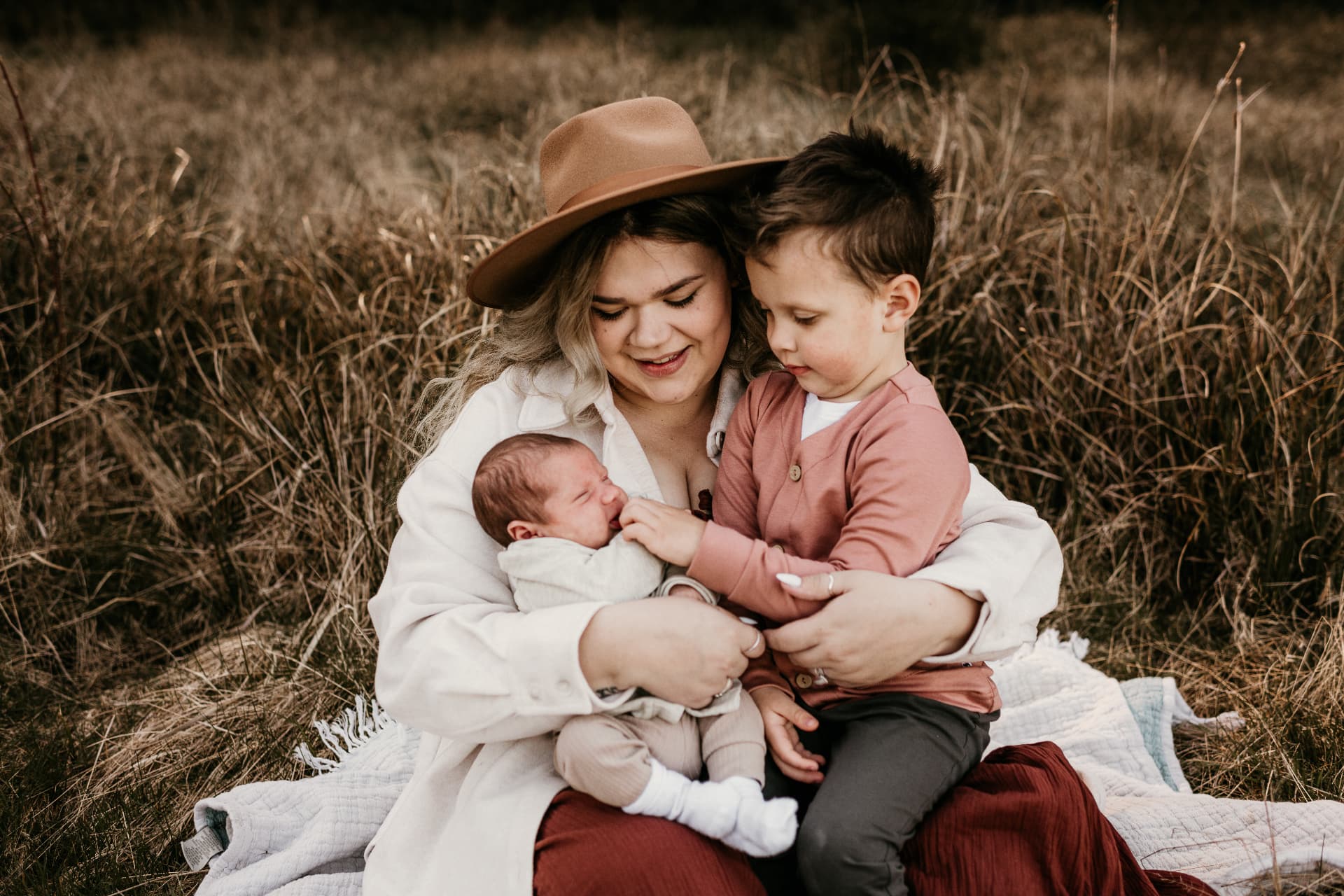 Brooklyn with her two sons in a field of dry grass